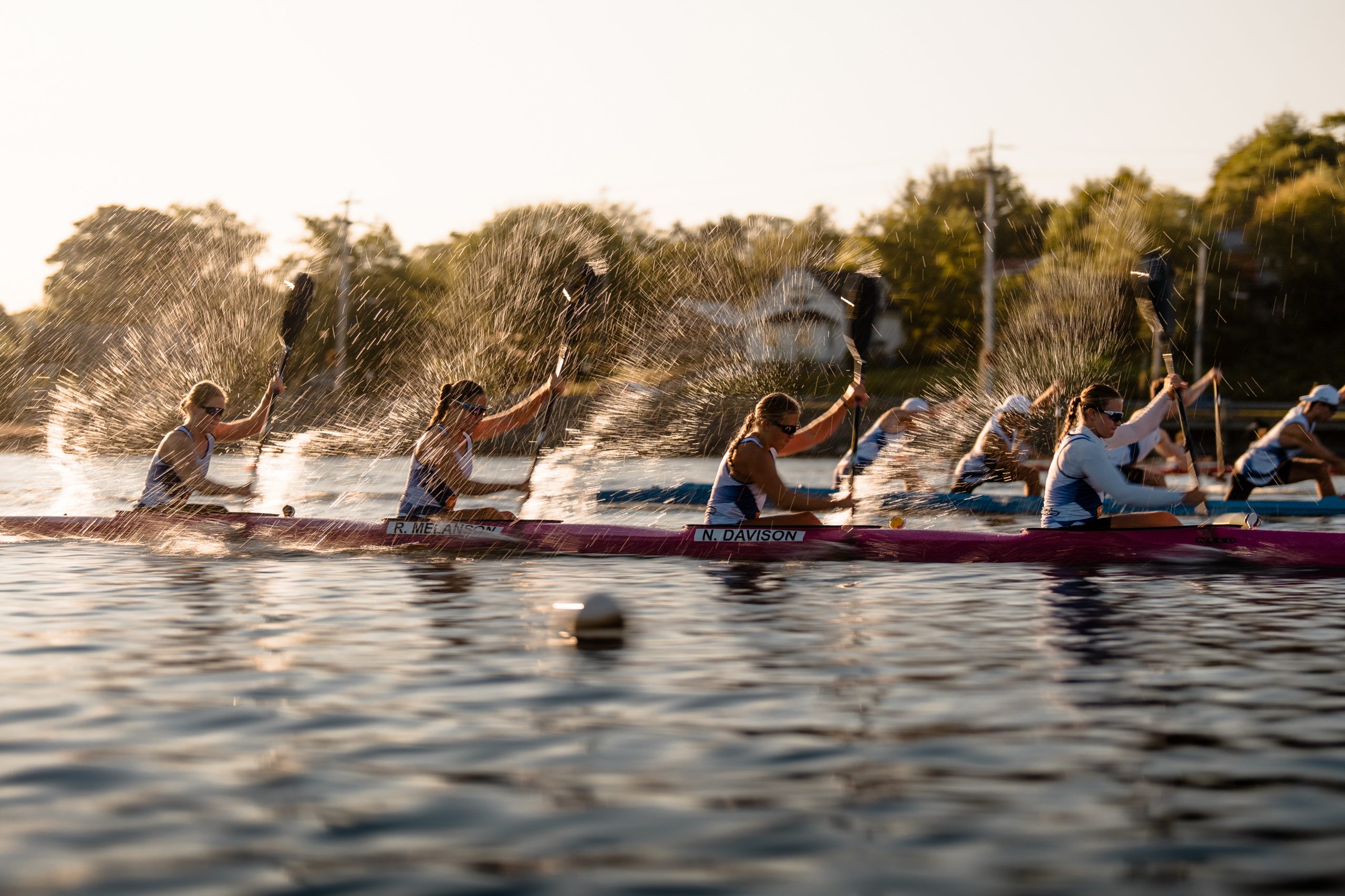 A group of paddlers race across Lake Banook in Nova Scotia