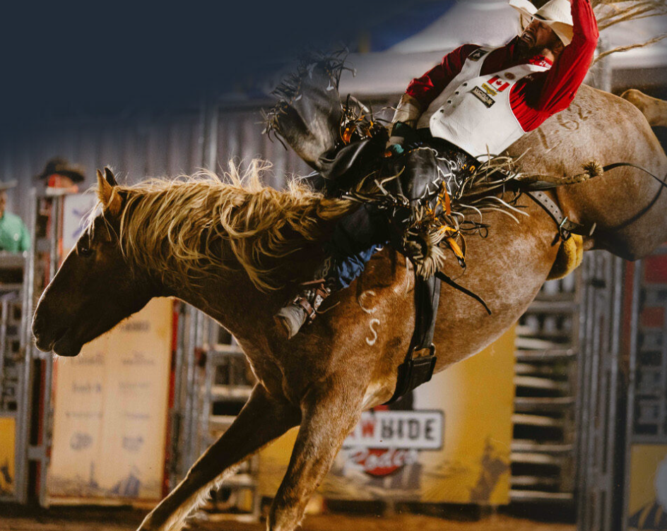 A cowboy rides a horse at the Cape Breton Island Pro Rodeo in Nova Scotia