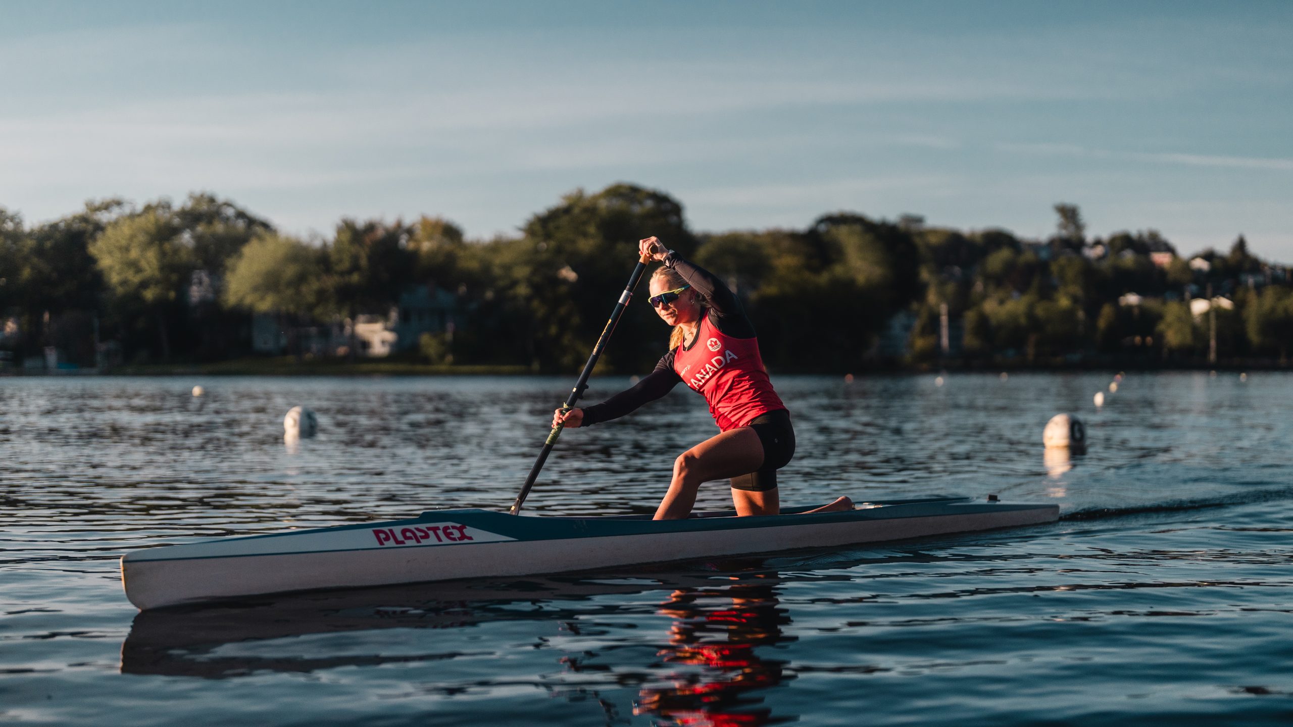 A person paddles on Lake Banook during the ICF Masters Canoe Sprint World Championships in Nova Scotia