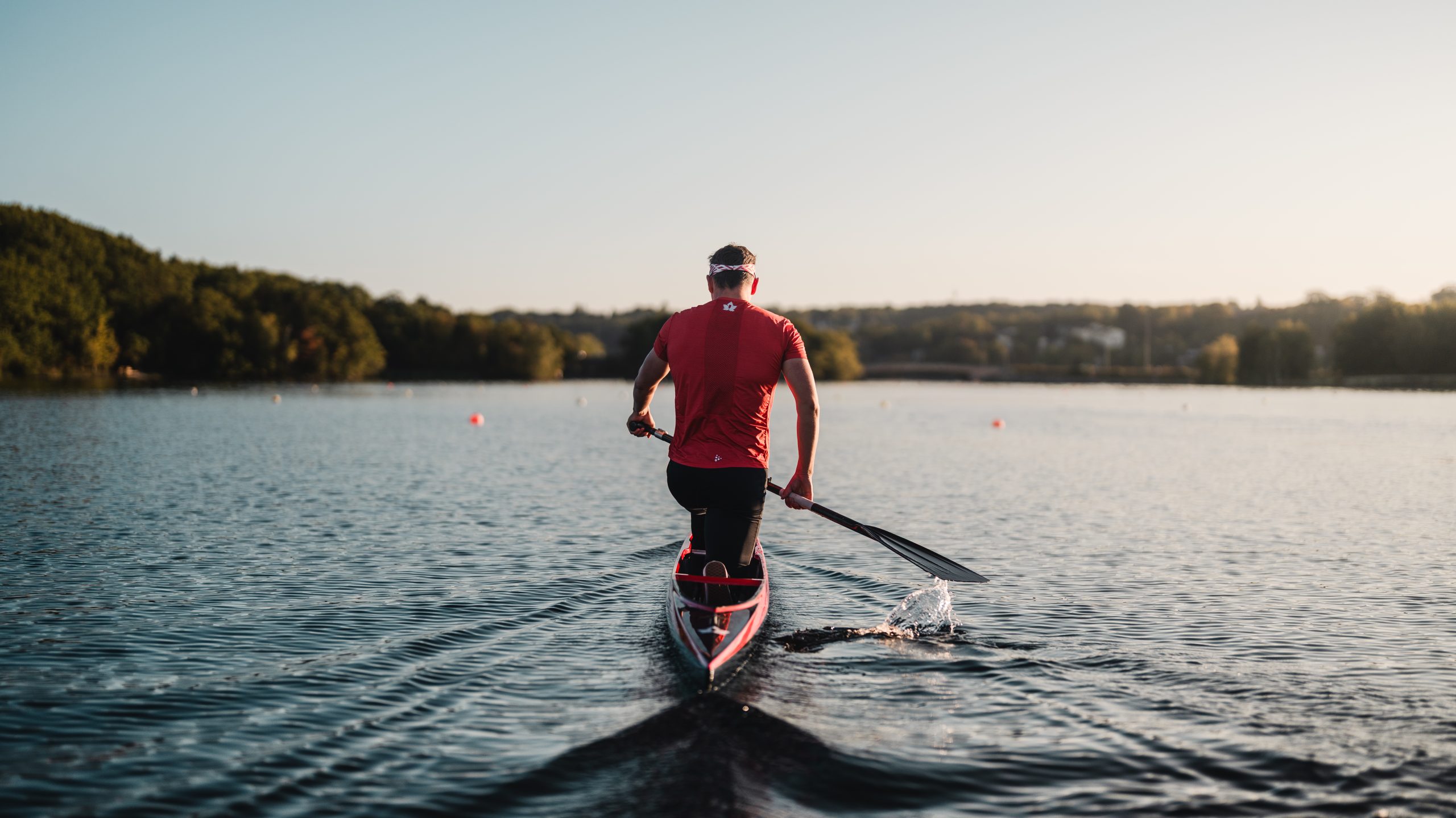 A person paddles on Lake Banook during the ICF Masters Canoe Sprint World Championships in Nova Scotia