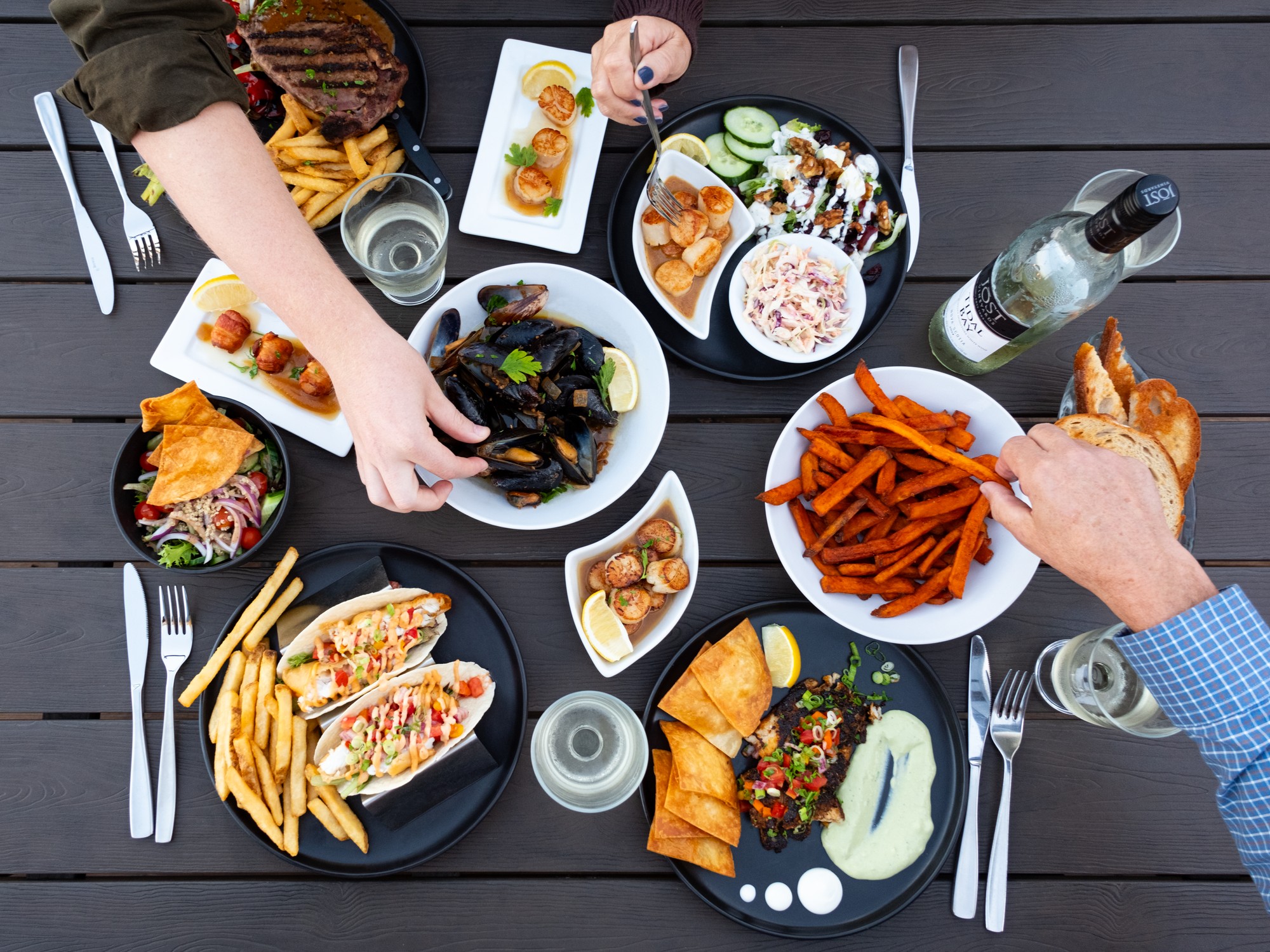 An overhead view of a variety of seafood dishes at the Sydney Street Pub in Digby, Nova Scotia