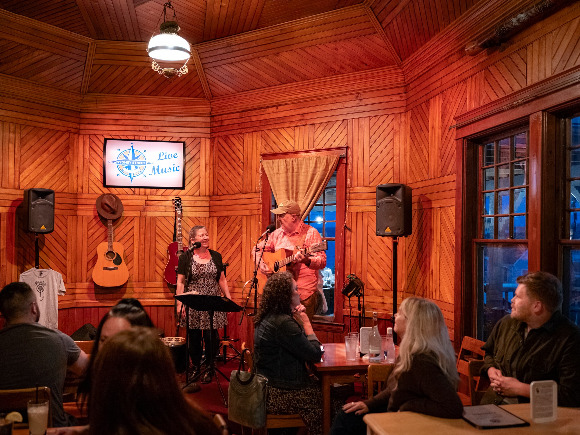 An audience listens to live music performance at Sydney Street Pub in Digby, Nova Scotia