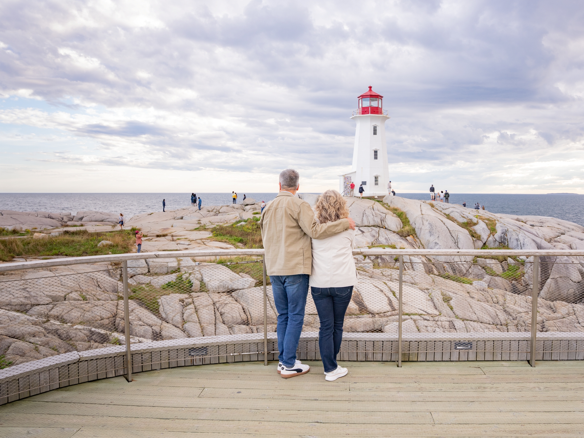 Couple standing on viewing deck overlooking Peggy's Cove