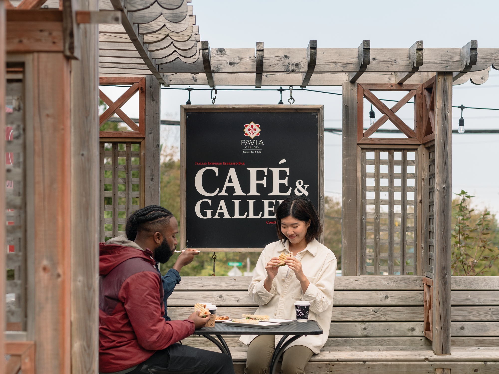 People sitting on a patio outside a cafe