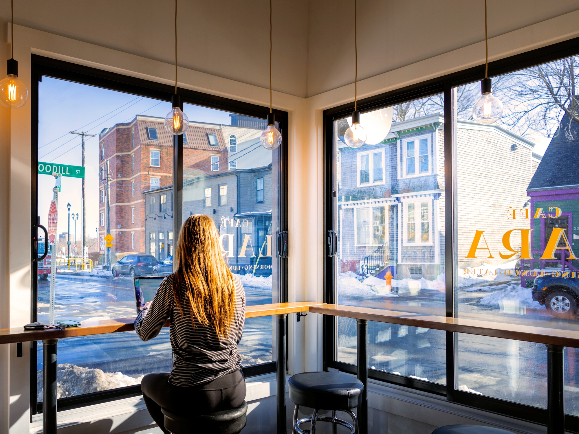 Person sitting in a cafe with lots of windows
