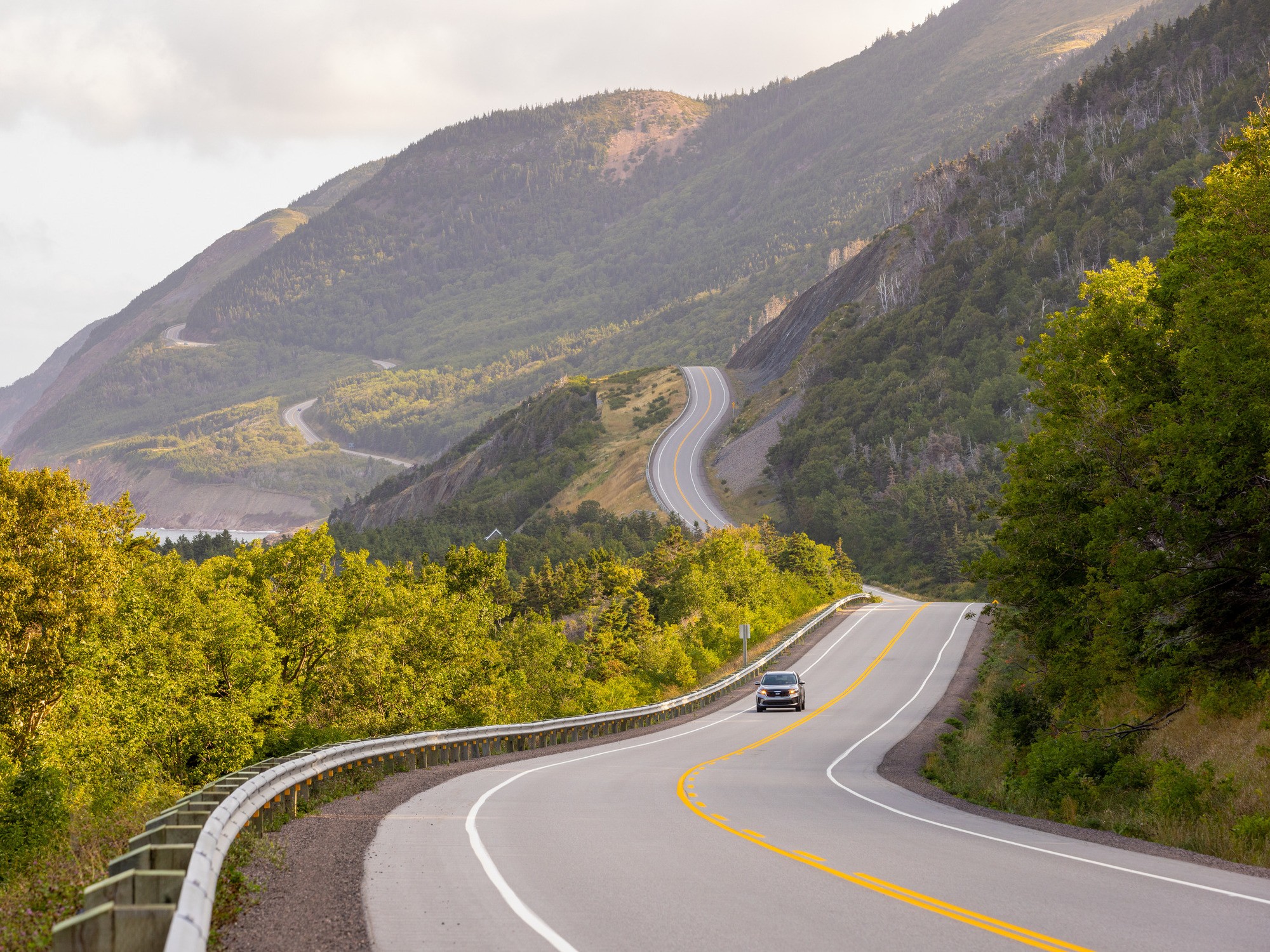 A car drives along the Cabot Trail in Nova Scotia