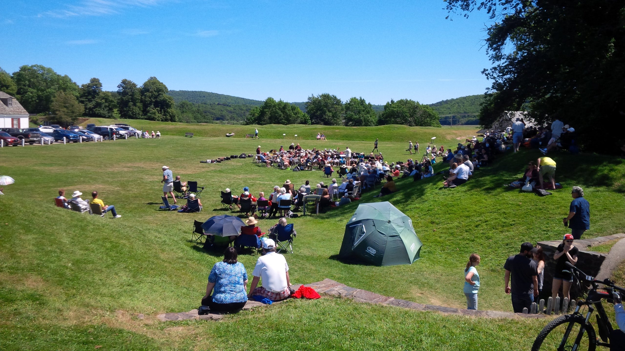 A group of people enjoying the Massed Band Concert at Fort Anne National Historic Site in Nova Scotia