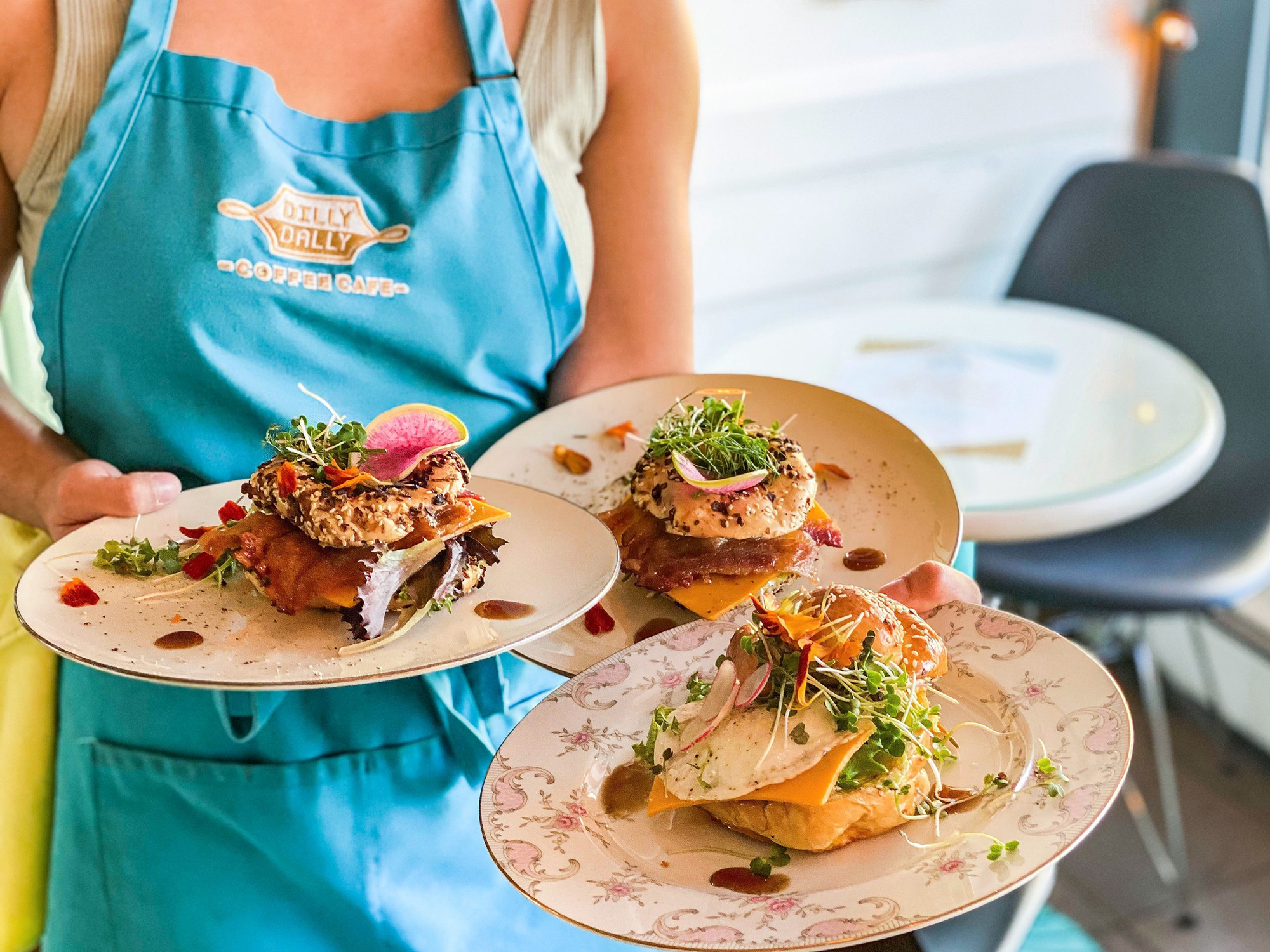 Person holding plates of brunch