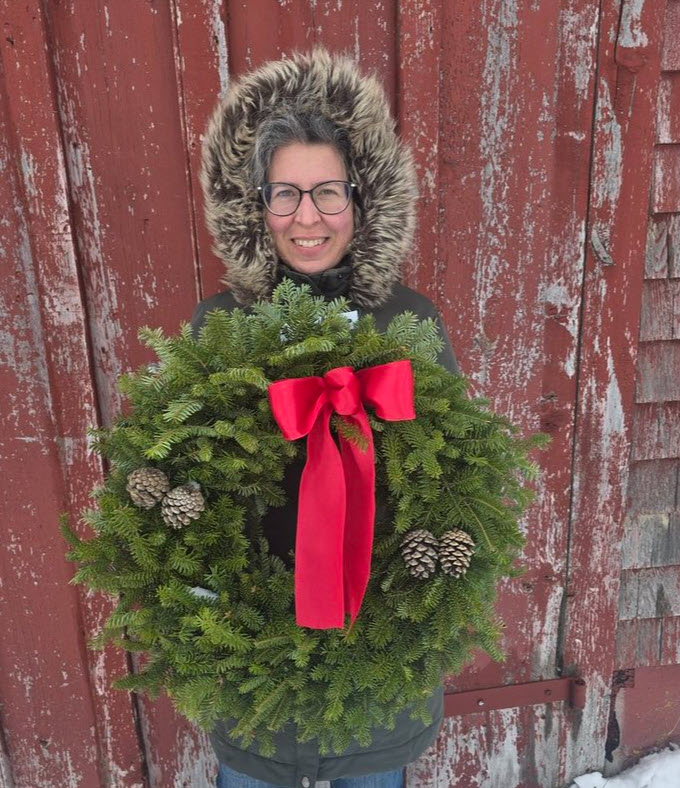 Woman holding a handmade wreath in New Ross, Nova Scotia.