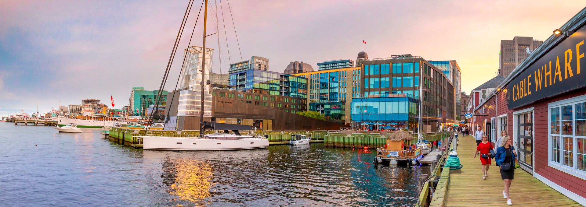 People walk on the Halifax Waterfront in Nova Scotia