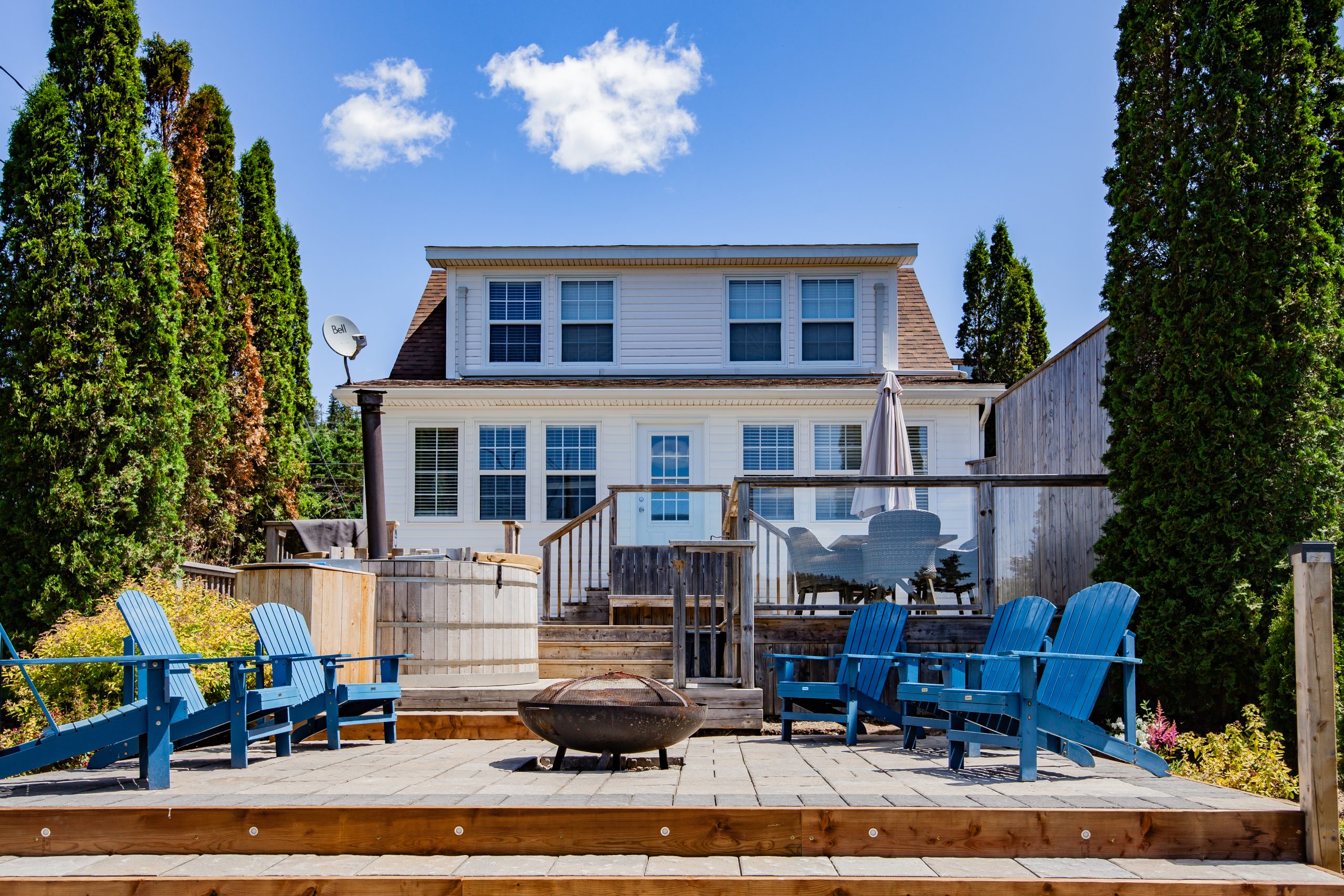 Front exterior view of cottage 8 with private hot tub and outdoor sitting area at Wilson's Coastal Club Resort in Nova Scotia
