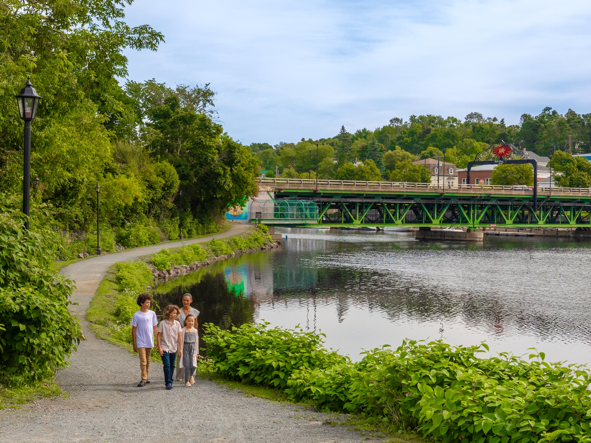 Family walking on Samson Trail beside the river
