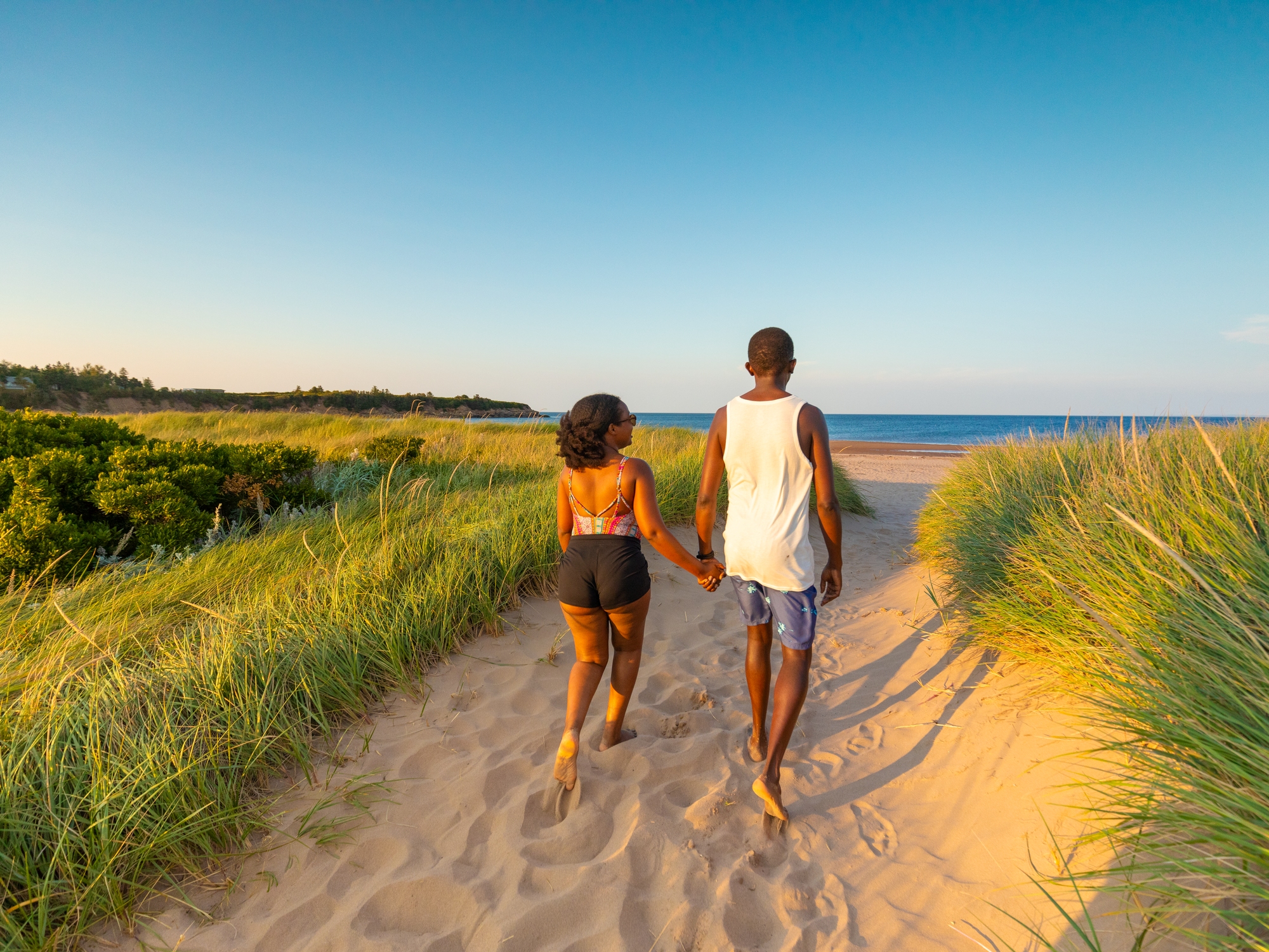 Couple running to Melmerby beach as the sun is starting to set.