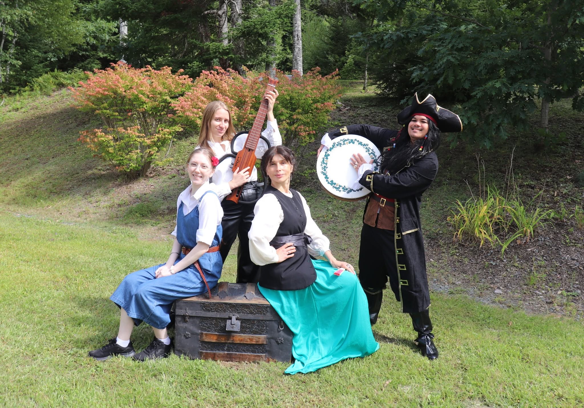 A promotional image of a group of performers in costumes with instruments