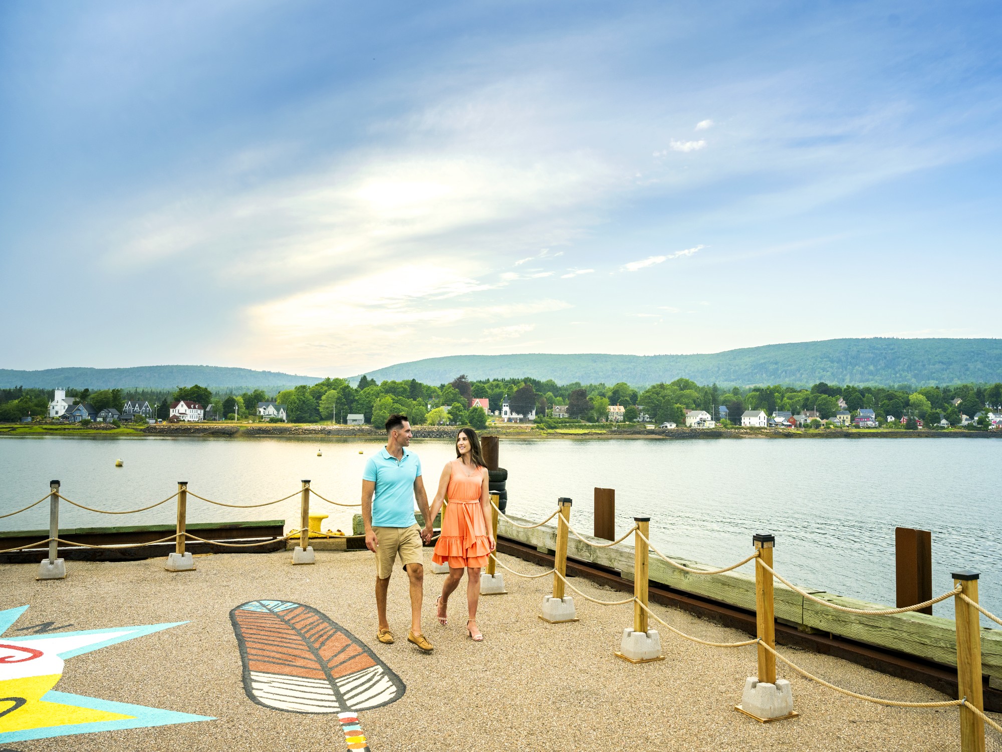 A couple walks along the Annapolis Royal Waterfront in Nova Scotia