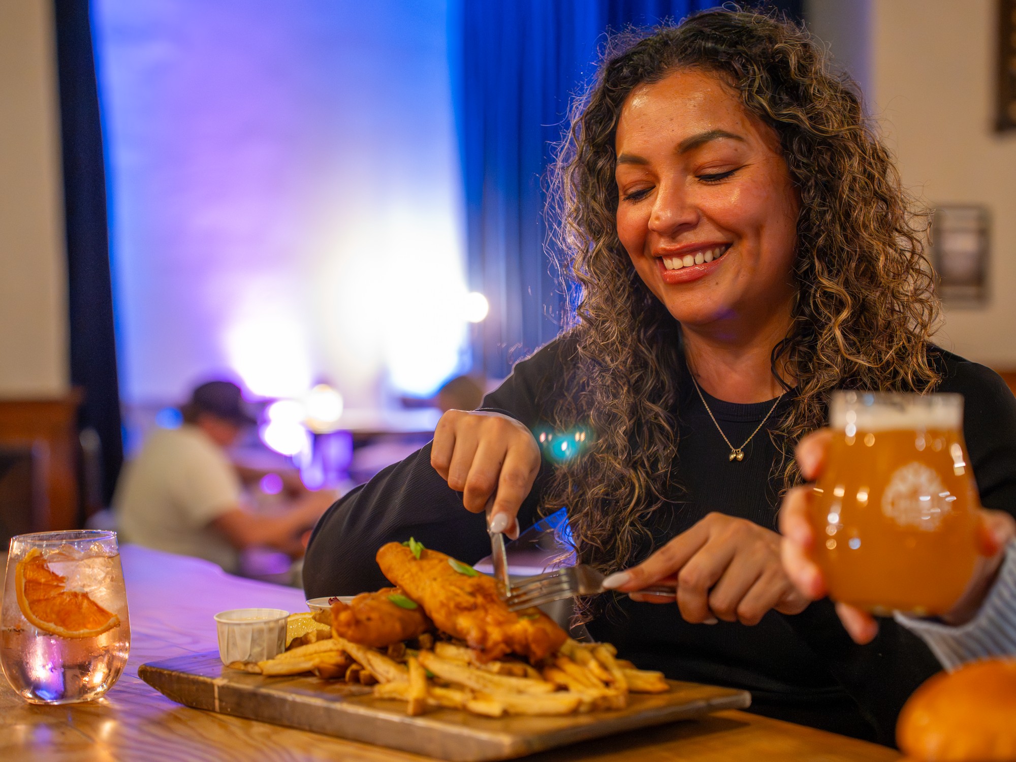 A person enjoys fish and chips at Church Brewing in Wolfville, Nova Scotia