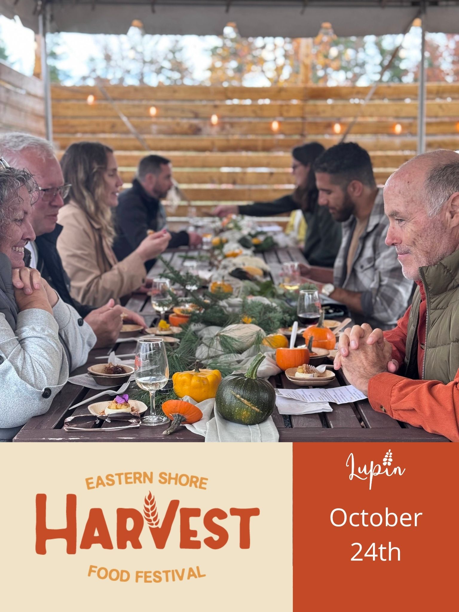 A group of people dining at a table at the Eastern Shore Harvest Food Festival in Nova Scotia