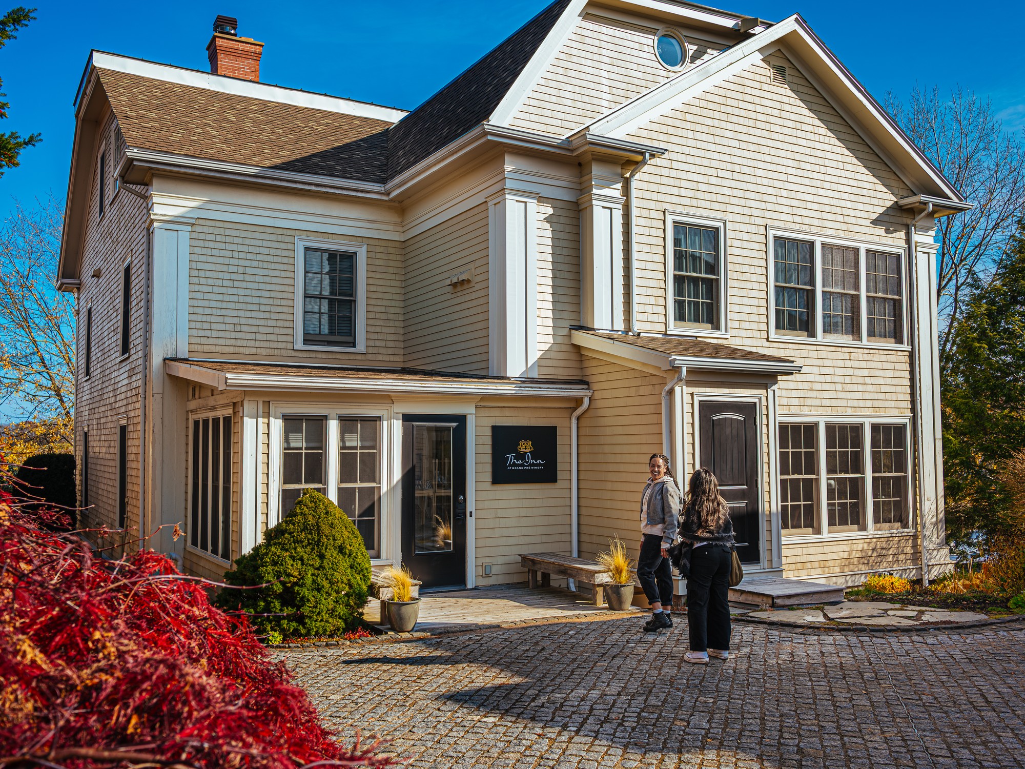 Two people are about to enter the Inn at Grand Pre Winery in Nova Scotia