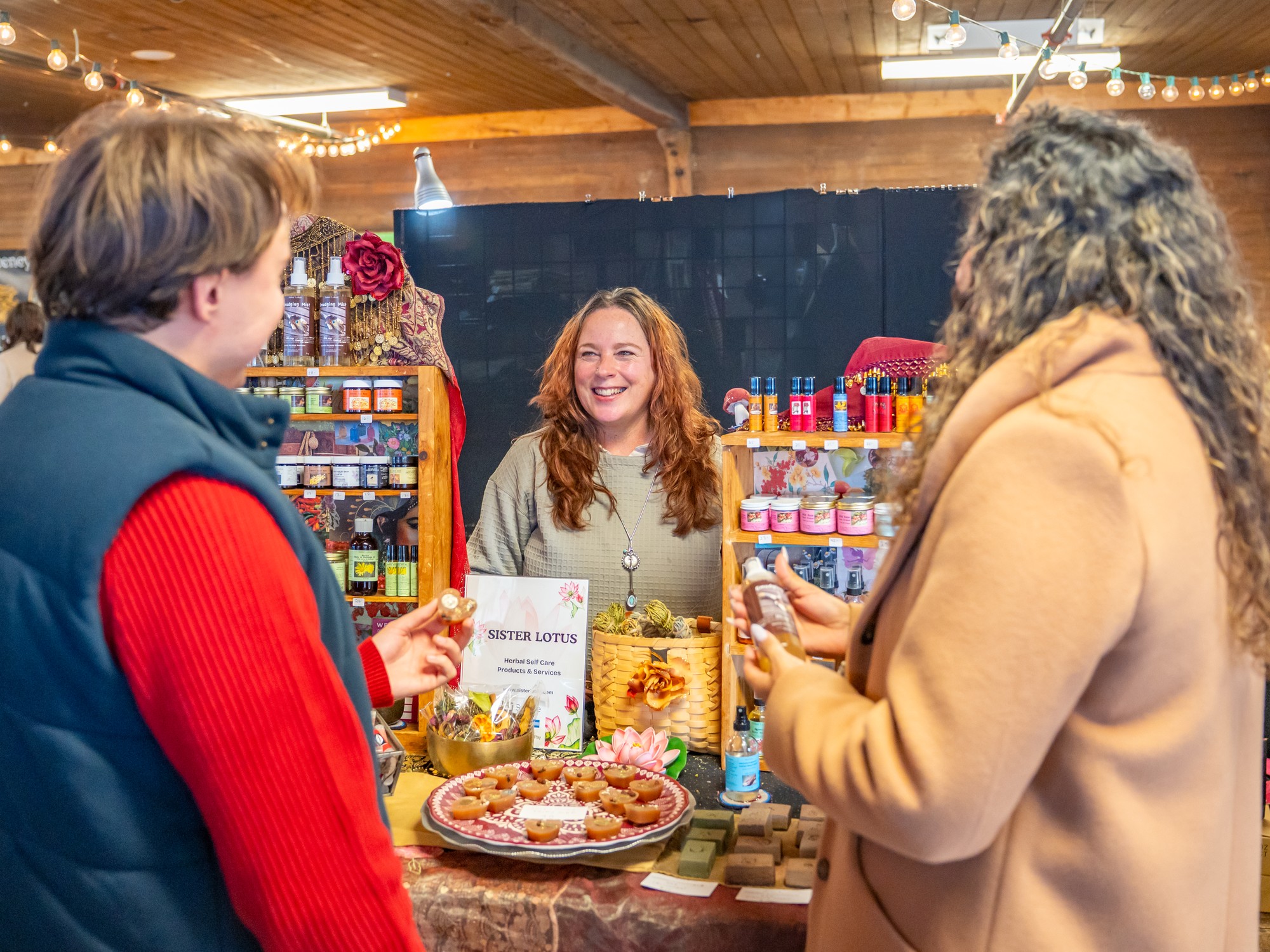 Two people chat with a vendor at the Wolfville Farmers Market in Nova Scotia
