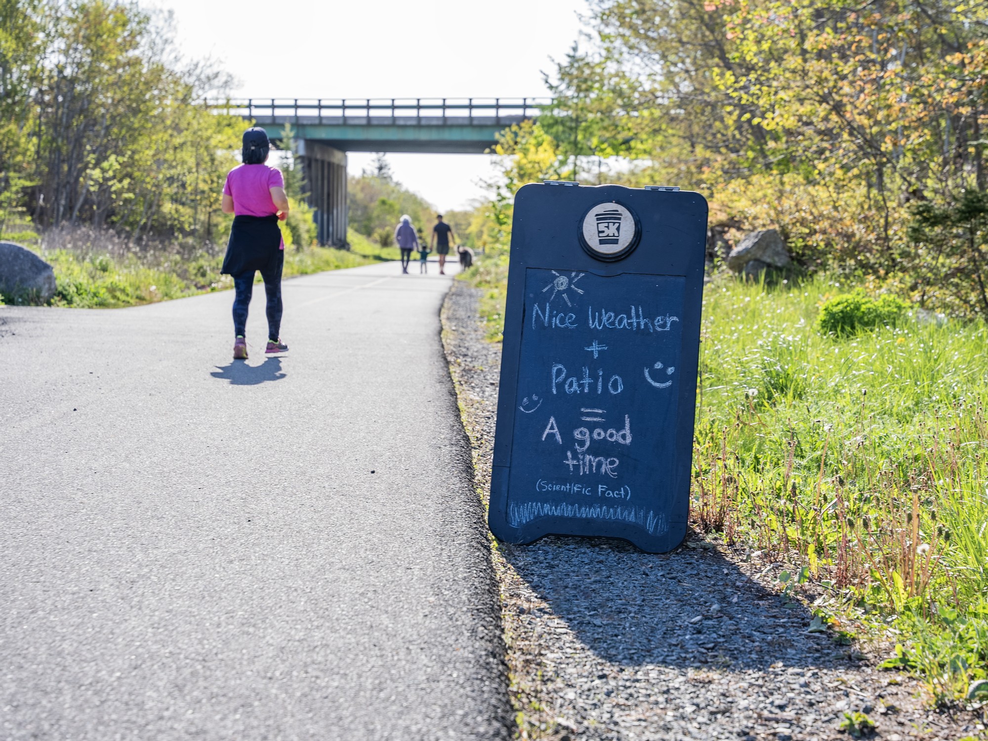 People walk along the Chain of Lakes Trail in Halifax, Nova Scotia