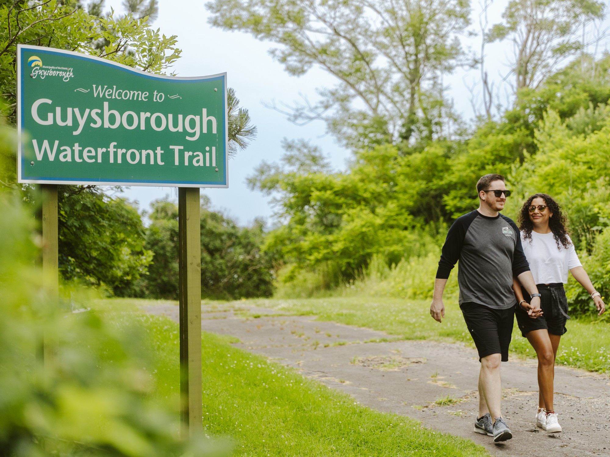 Two people walk on the Guysborough Waterfront Trail in Guysborough