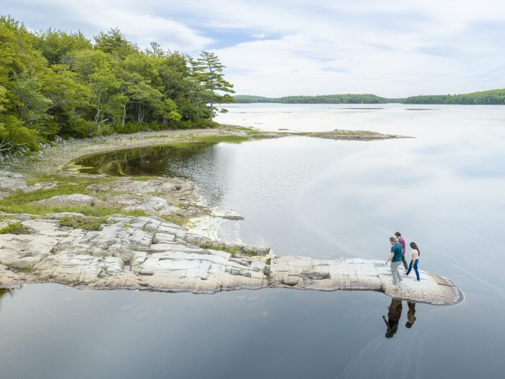 People take part in a petroglyphs tour at Kejimkujik National Park & National Historic Site in Nova Scotia