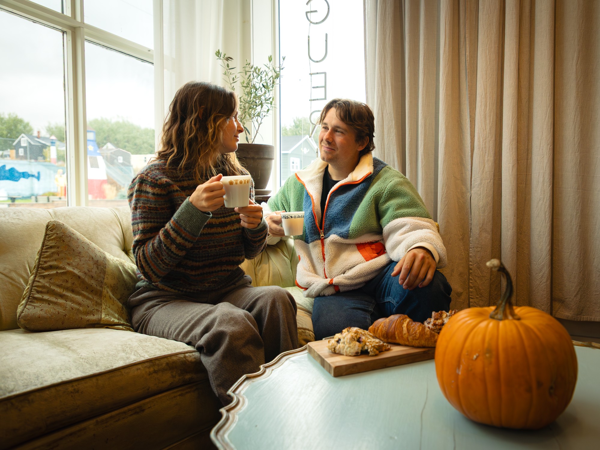 Two people have coffee and pastries at Marguerite Boutique et Provisions in Cheticamp, Nova Scotia
