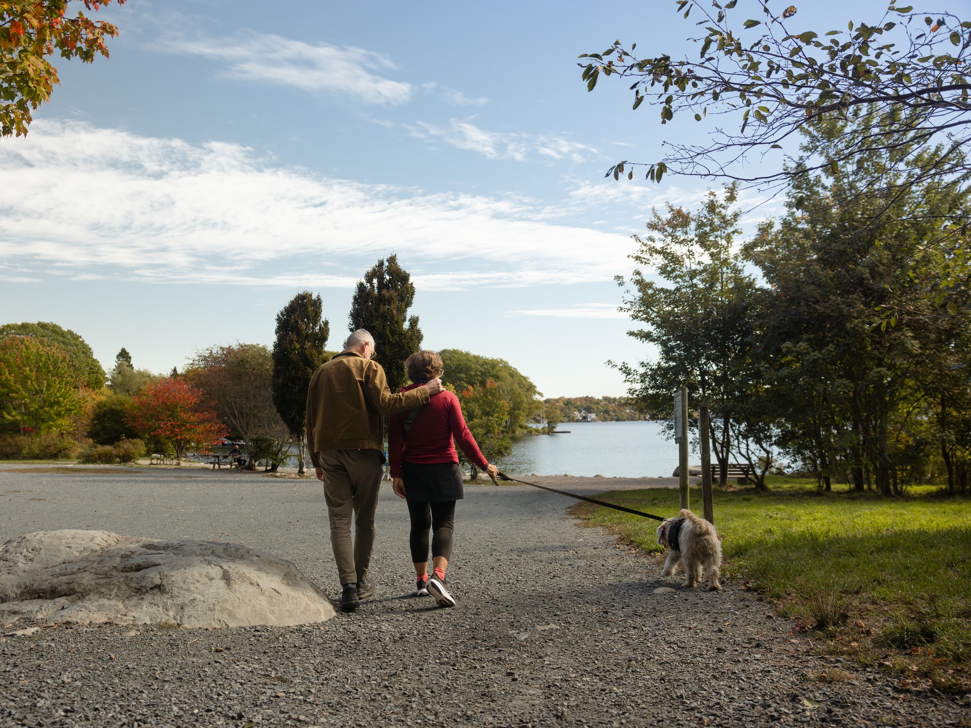 A couple walks their dog at Shubie Park in Dartmouth, Nova Scotia