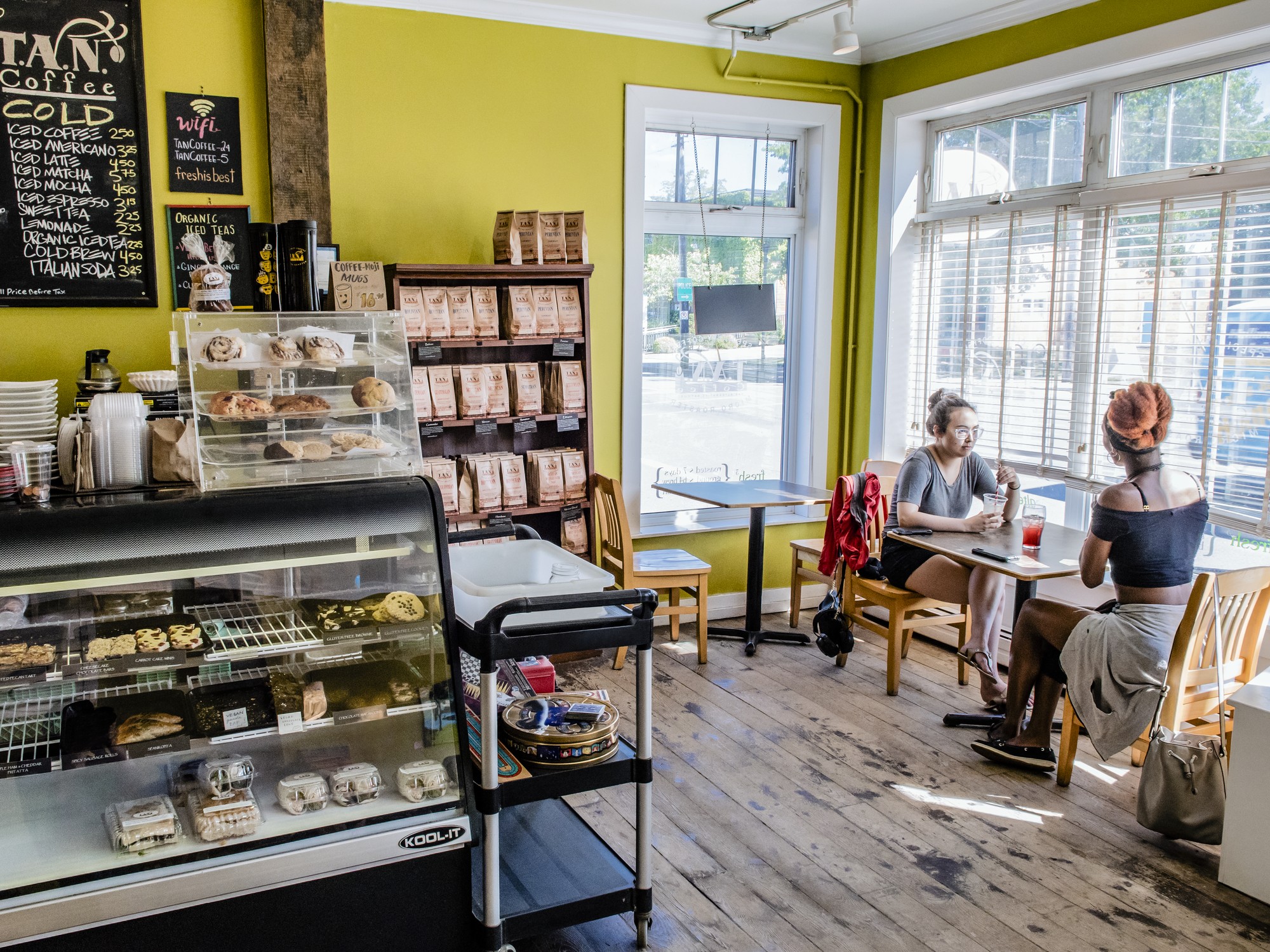 Two people sit at a table at TAN Coffee in Wolfville, Nova Scotia