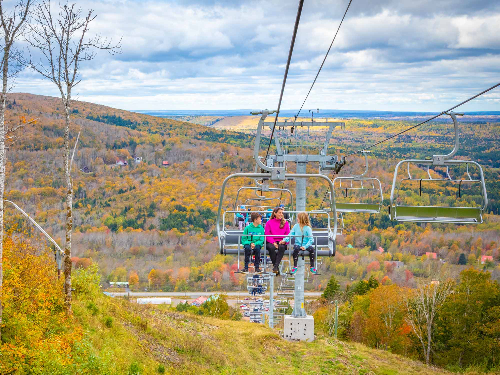 Family on the ski lift at Ski Wentworth and Wentworth Bike Park during the annual Fall colours in Nova Scotia.